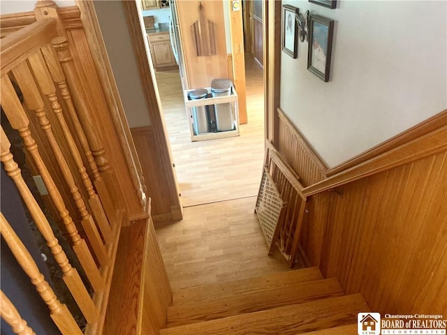 9983 Deer Creek Rd, Genesee, NY 14770 - stairway with wood finished floors and a wainscoted wall