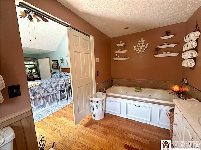 9983 Deer Creek Rd, Genesee, NY 14770 - full bath featuring a textured ceiling, a jetted tub, and wood finished floors