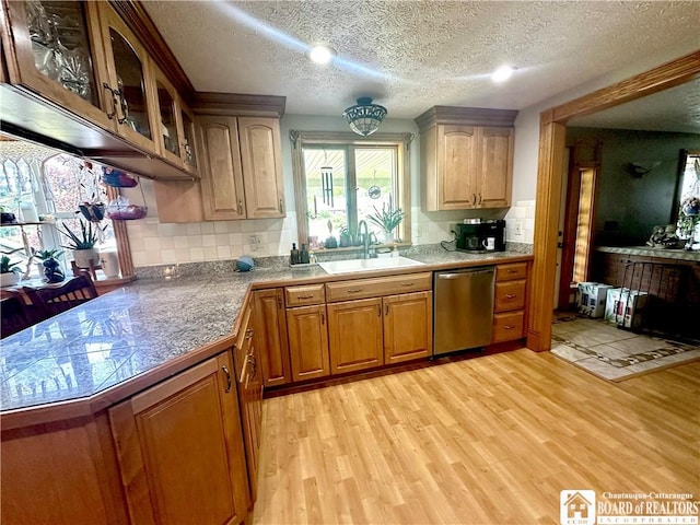9983 Deer Creek Rd, Genesee, NY 14770 - kitchen featuring dishwasher, light wood-style flooring, glass insert cabinets, a sink, and a textured ceiling