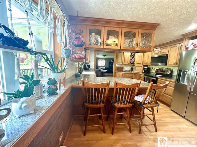 9983 Deer Creek Rd, Genesee, NY 14770 - kitchen featuring stainless steel appliances, a sink, glass insert cabinets, ornamental molding, and light wood finished floors