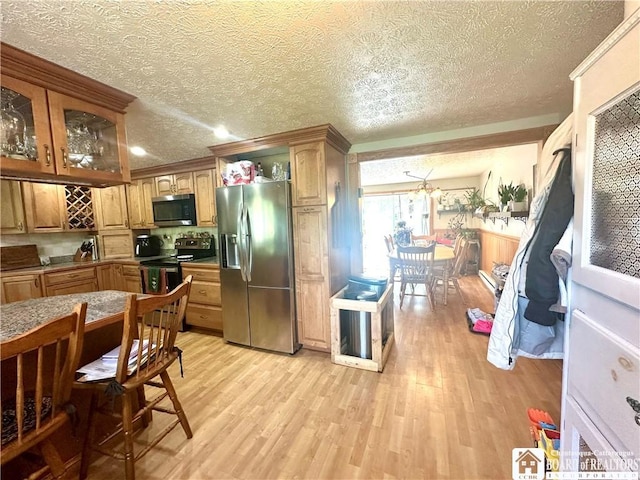 9983 Deer Creek Rd, Genesee, NY 14770 - kitchen with appliances with stainless steel finishes, light wood-type flooring, a textured ceiling, glass insert cabinets, and crown molding