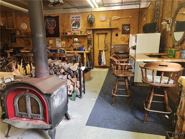 381 French Rd, Morehouse, NY 13324 - misc room featuring a wood stove and concrete flooring