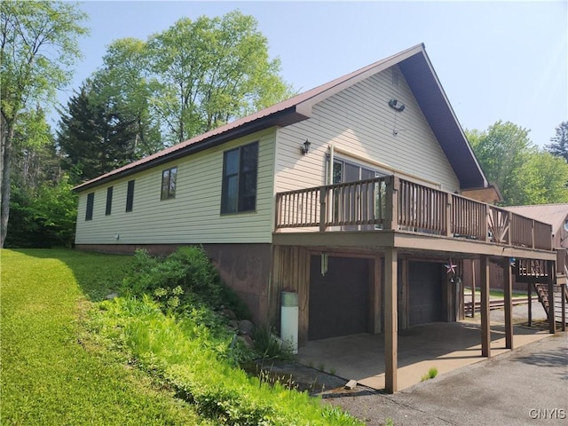 381 French Rd, Morehouse, NY 13324 - rear view of property featuring stairway, an attached garage, a lawn, a wooden deck, and metal roof