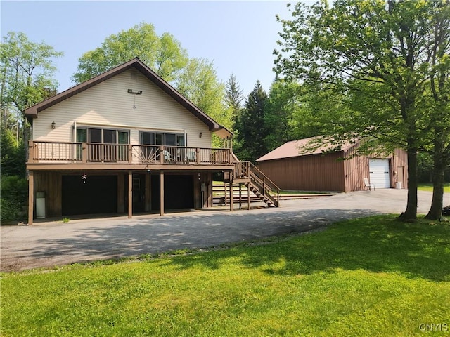 381 French Rd, Morehouse, NY 13324 - view of front of home featuring stairs, a wooden deck, a front lawn, driveway, and an outbuilding