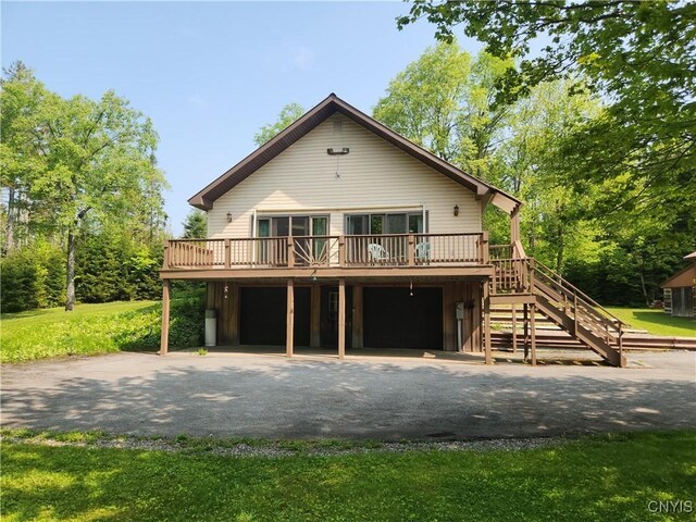 381 French Rd, Morehouse, NY 13324 - view of front of home with driveway, a deck, a garage, and stairs
