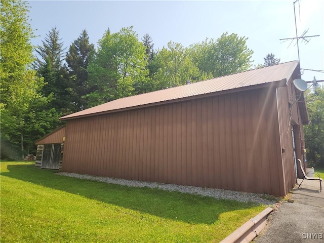 381 French Rd, Morehouse, NY 13324 - view of side of home with a yard, metal roof, and an outbuilding