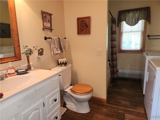 381 French Rd, Morehouse, NY 13324 - bathroom featuring washer and clothes dryer, vanity, wood finished floors, toilet, and baseboards