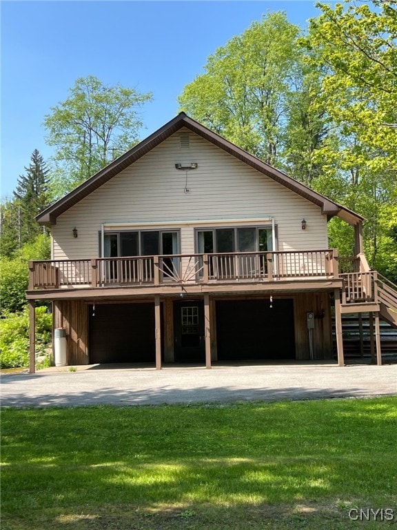 381 French Rd, Morehouse, NY 13324 - view of front of house with a wooden deck, stairway, a front lawn, and a garage