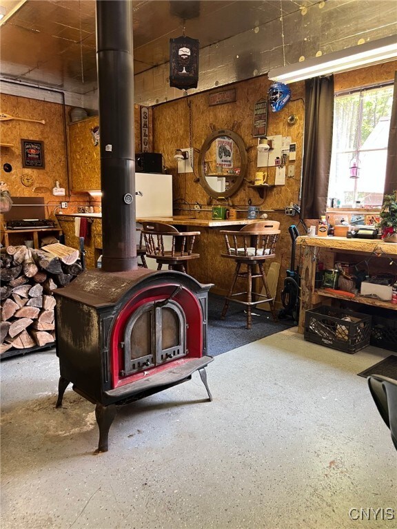381 French Rd, Morehouse, NY 13324 - rec room featuring a wood stove and a workshop area