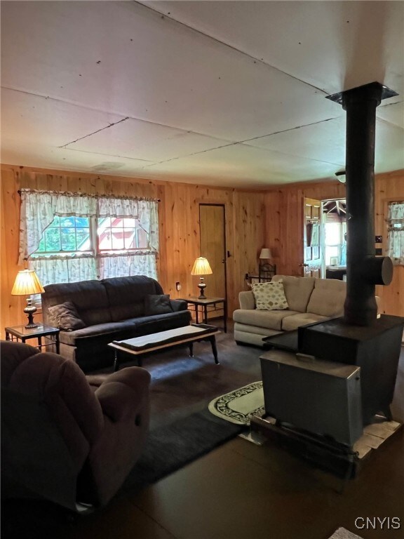 381 French Rd, Morehouse, NY 13324 - living room featuring a wood stove and wood walls