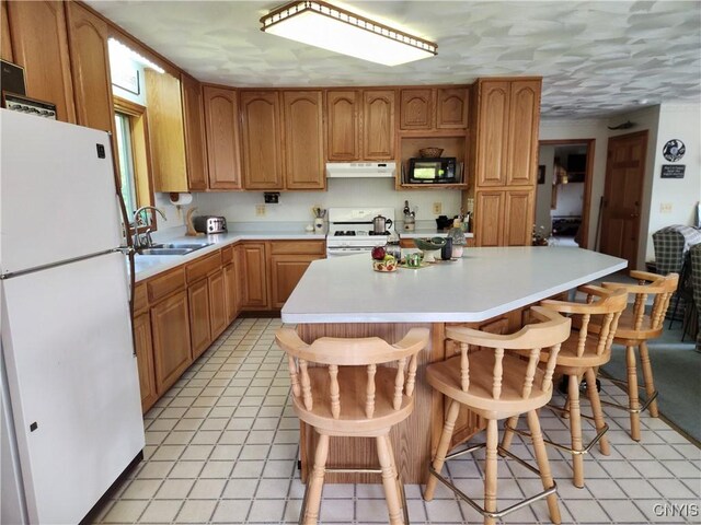 381 French Rd, Morehouse, NY 13324 - kitchen with white appliances, under cabinet range hood, a sink, light countertops, and a kitchen island
