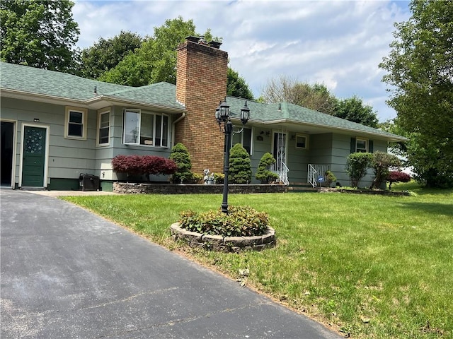 793 Helendale Rd, Irondequoit, NY 14609 - ranch-style house with a chimney, a shingled roof, and a front yard
