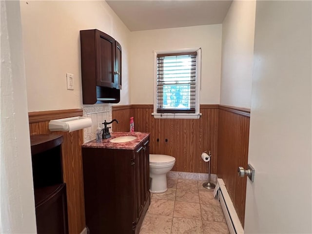 793 Helendale Rd, Irondequoit, NY 14609 - bathroom with toilet, baseboard heating, wainscoting, vanity, and wood walls