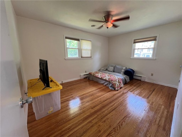 793 Helendale Rd, Irondequoit, NY 14609 - bedroom featuring a baseboard radiator, wood finished floors, baseboards, and a ceiling fan