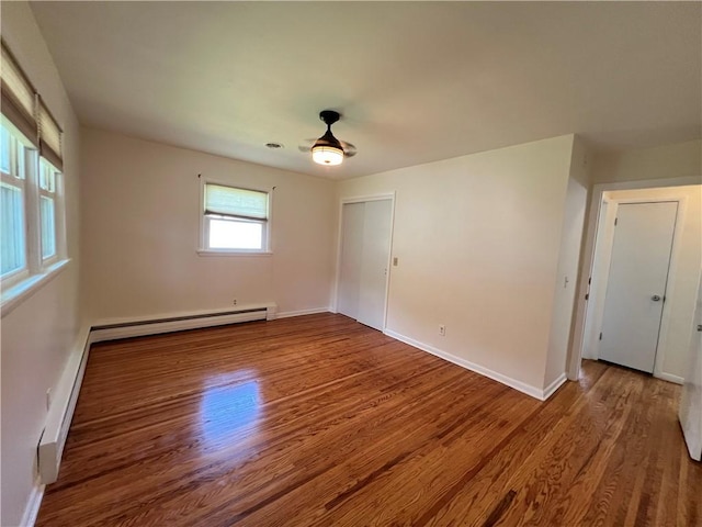 793 Helendale Rd, Irondequoit, NY 14609 - empty room featuring wood finished floors, baseboard heating, baseboards, and a ceiling fan