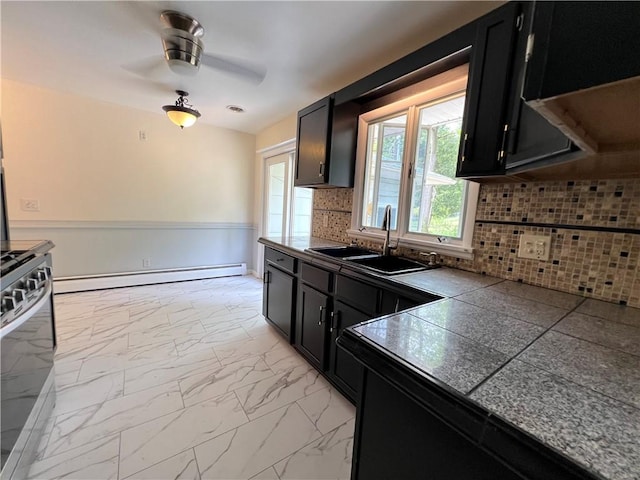 793 Helendale Rd, Irondequoit, NY 14609 - kitchen featuring dark cabinetry, a sink, baseboard heating, and stainless steel stove