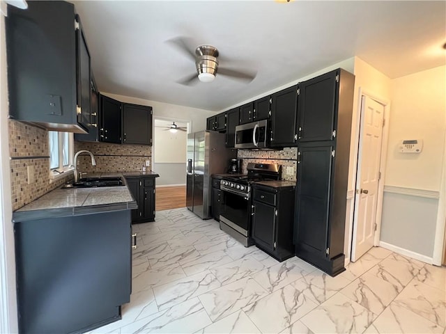 793 Helendale Rd, Irondequoit, NY 14609 - kitchen featuring appliances with stainless steel finishes, a ceiling fan, a sink, baseboards, and dark cabinets