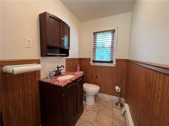 793 Helendale Rd, Irondequoit, NY 14609 - bathroom featuring a baseboard heating unit, a wainscoted wall, vanity, toilet, and marble finish floors