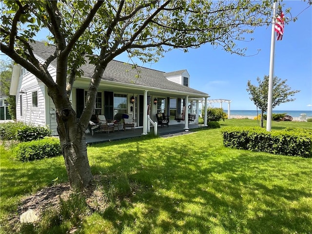 14415 Oak Orchard On The Lk, Carlton, NY 14571 - back of property featuring a shingled roof, a yard, and a water view