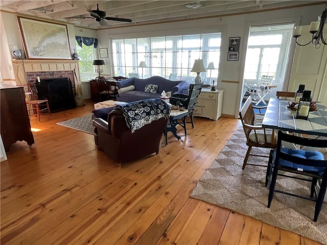 14415 Oak Orchard On The Lk, Carlton, NY 14571 - living room featuring light wood-type flooring, a ceiling fan, and a fireplace