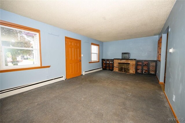 965 Walden Ave, Buffalo, NY 14211 - unfurnished living room featuring a baseboard radiator, a textured ceiling, carpet flooring, and baseboards