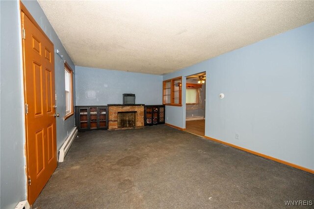 965 Walden Ave, Buffalo, NY 14211 - unfurnished living room with baseboard heating, a fireplace, carpet, a textured ceiling, and baseboards