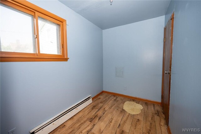 965 Walden Ave, Buffalo, NY 14211 - empty room featuring a baseboard radiator, hardwood / wood-style floors, and baseboards