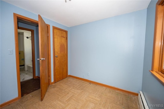 965 Walden Ave, Buffalo, NY 14211 - unfurnished bedroom with baseboard heating, baseboards, and a closet