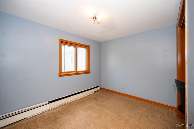 965 Walden Ave, Buffalo, NY 14211 - unfurnished room featuring a baseboard heating unit and baseboards