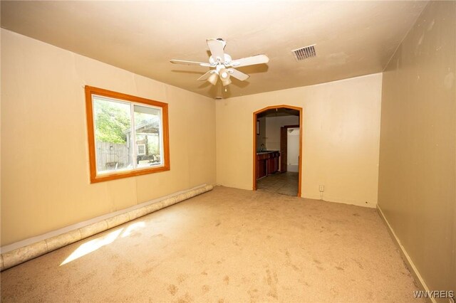 965 Walden Ave, Buffalo, NY 14211 - carpeted empty room with arched walkways and ceiling fan