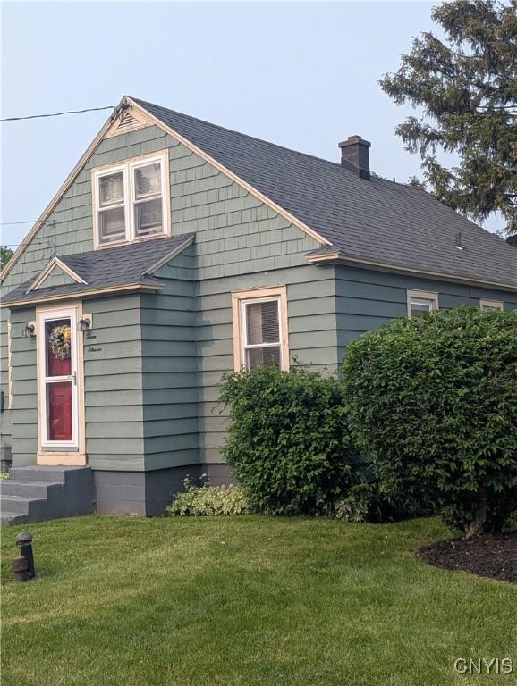 311 Raphael Ave, Salina, NY 13211 - bungalow-style home featuring a chimney, a front yard, a shingled roof, and entry steps