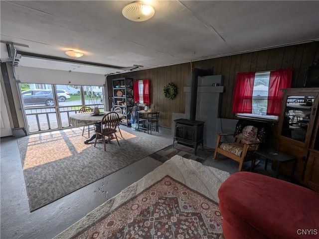311 Raphael Ave, Salina, NY 13211 - living room with a wood stove, healthy amount of natural light, and wooden walls
