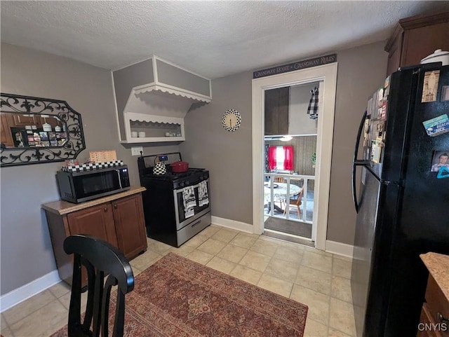 311 Raphael Ave, Salina, NY 13211 - kitchen featuring black appliances, a textured ceiling, light countertops, baseboards, and light tile patterned flooring