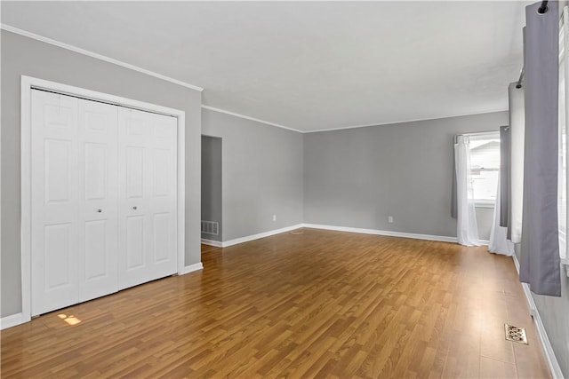 43 Hager Rd, Greece, NY 14616 - unfurnished bedroom with wood finished floors, ornamental molding, baseboards, and a closet