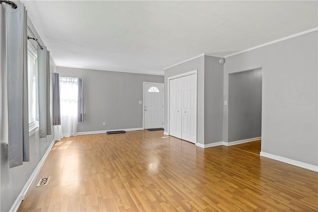 43 Hager Rd, Greece, NY 14616 - unfurnished living room featuring light wood-style floors, baseboards, and crown molding