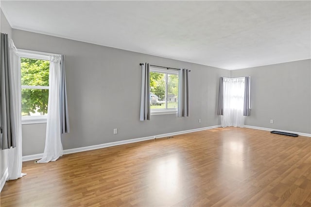 43 Hager Rd, Greece, NY 14616 - empty room with plenty of natural light, light wood-style floors, and baseboards