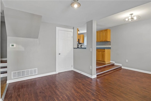 43 Hager Rd, Greece, NY 14616 - unfurnished living room with dark wood-type flooring and baseboards