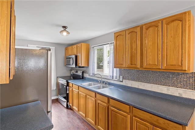 43 Hager Rd, Greece, NY 14616 - kitchen featuring stainless steel appliances, a sink, backsplash, dark wood-style floors, and brown cabinetry