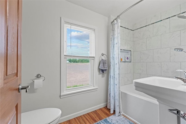 13385 Seneca St, Savannah, NY 13146 - bathroom with toilet, shower / tub combo, wood finished floors, and baseboards