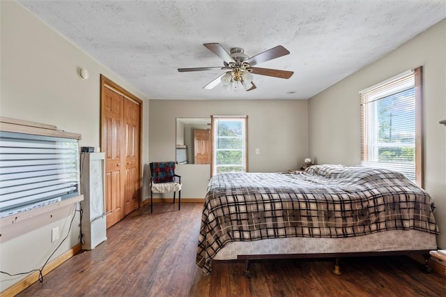 13385 Seneca St, Savannah, NY 13146 - bedroom featuring wood finished floors, a textured ceiling, baseboards, a ceiling fan, and access to exterior