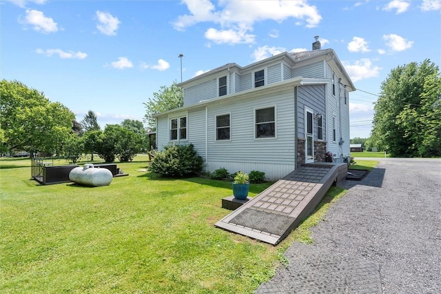 13385 Seneca St, Savannah, NY 13146 - rear view of house featuring a lawn and a chimney