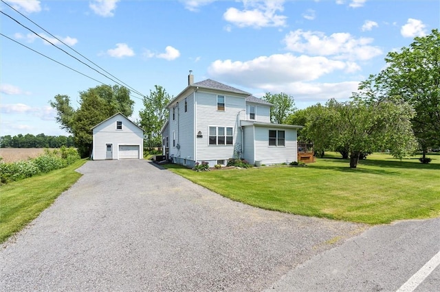 13385 Seneca St, Savannah, NY 13146 - view of front of home featuring a detached garage, an outdoor structure, a front lawn, and a chimney