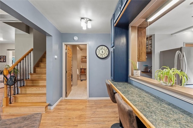 13385 Seneca St, Savannah, NY 13146 - foyer entrance featuring light wood finished floors, stairway, and baseboards