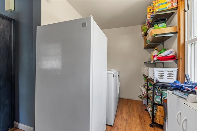13385 Seneca St, Savannah, NY 13146 - laundry area with washing machine and clothes dryer and light wood-style floors