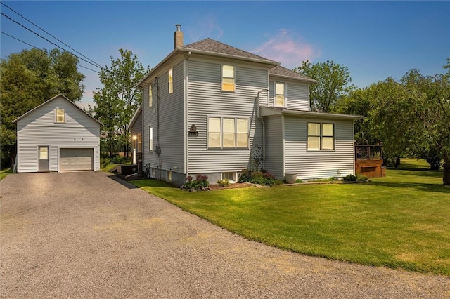 13385 Seneca St, Savannah, NY 13146 - rear view of property featuring an outdoor structure, a detached garage, a chimney, and a lawn