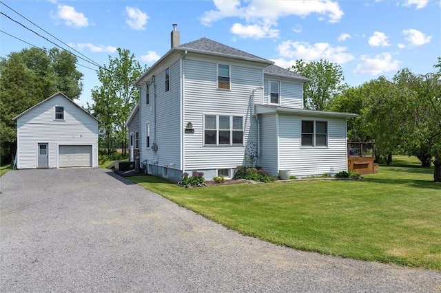 13385 Seneca St, Savannah, NY 13146 - rear view of property with an outbuilding, a detached garage, a chimney, a lawn, and driveway