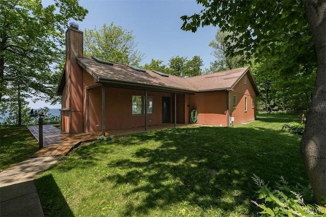4859 Becker Ln, Lyme, NY 13693 - back of house featuring a chimney and a lawn