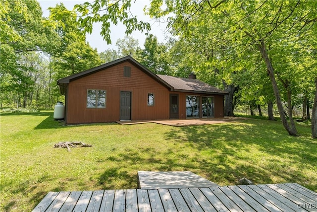 4859 Becker Ln, Lyme, NY 13693 - back of house with a lawn, a chimney, and a patio area