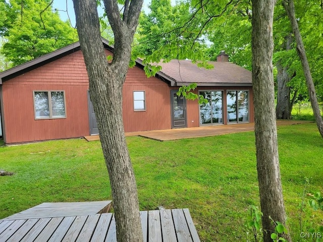 4859 Becker Ln, Lyme, NY 13693 - rear view of property featuring a yard, a chimney, and a deck