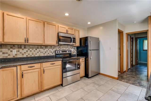 4859 Becker Ln, Lyme, NY 13693 - kitchen featuring stainless steel appliances, light brown cabinetry, dark countertops, decorative backsplash, and baseboards